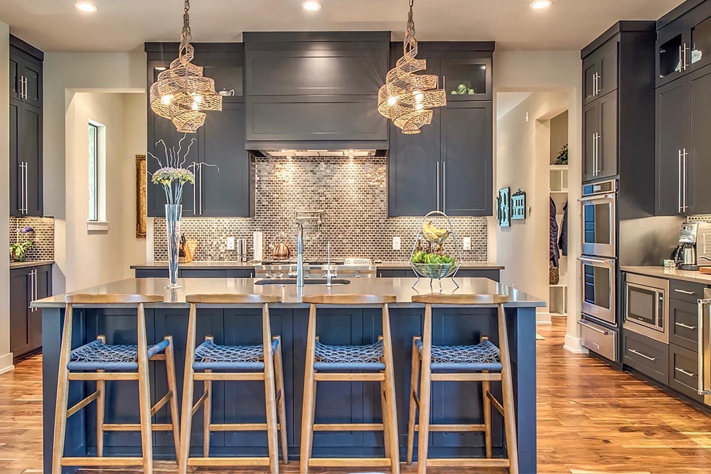 Custom navy shaker kitchen with wood-topped island seating and hardwood floors